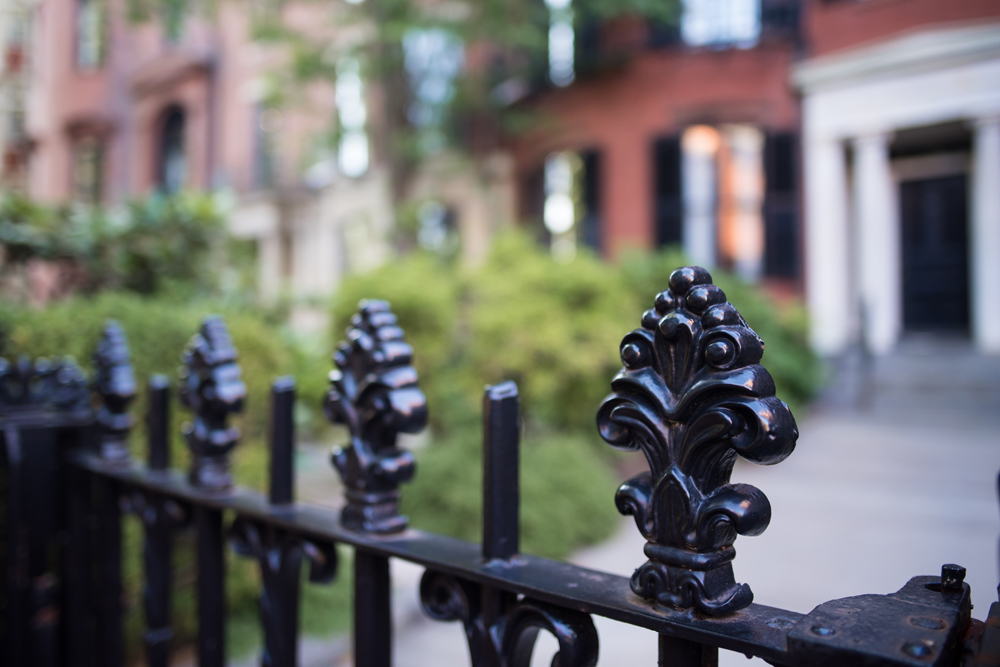 Black decorative fence in front of a house